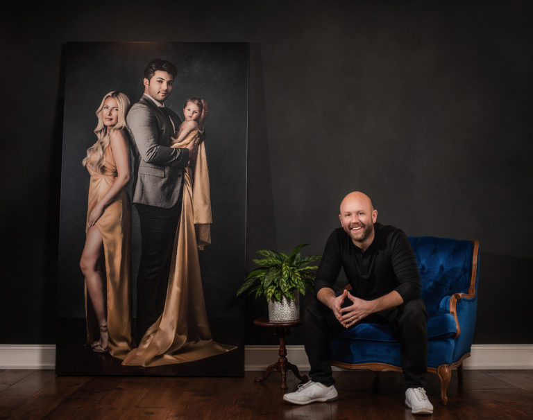 Neal Urban poses with life size portrait canvas